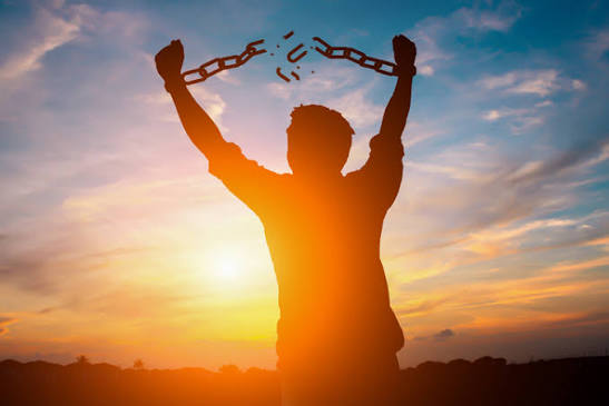 silhouette man breaking chains sunrise freedom